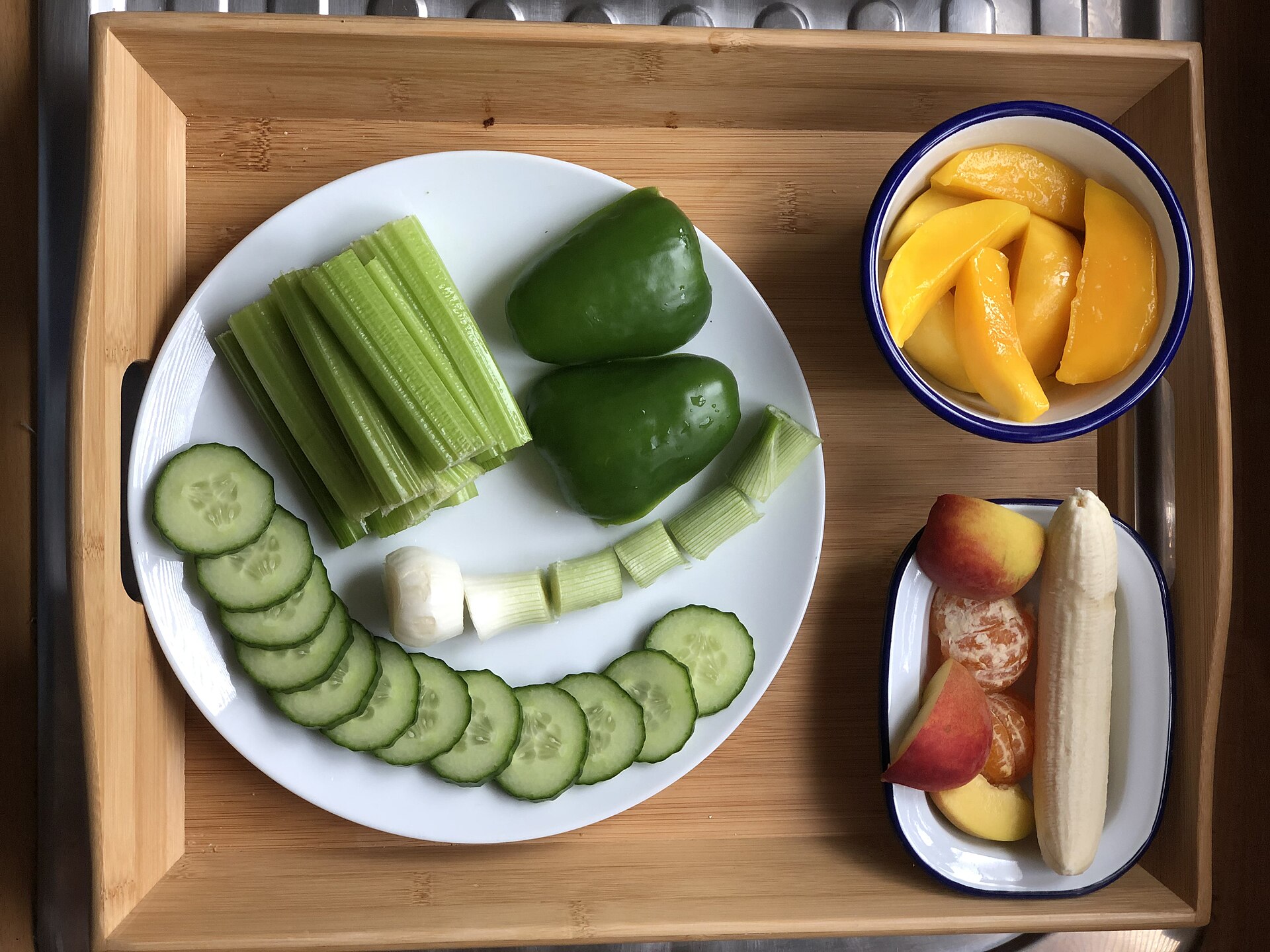 Fresh vegetables and fruit arranged on plates
