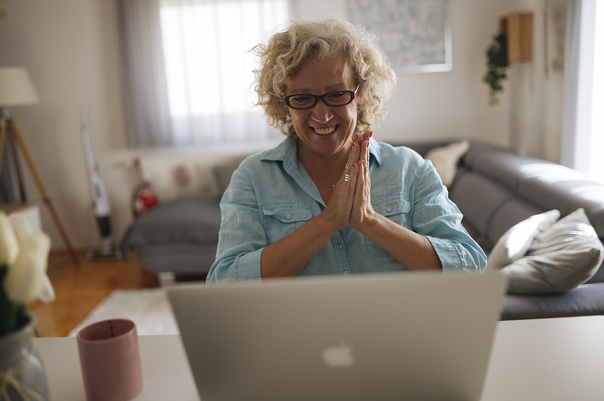 An older woman smiling during a telehealth video visit from home